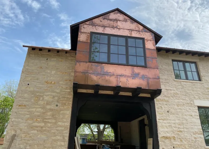 Copper metal panel facade on a stone building for Roof Repair in South Elgin