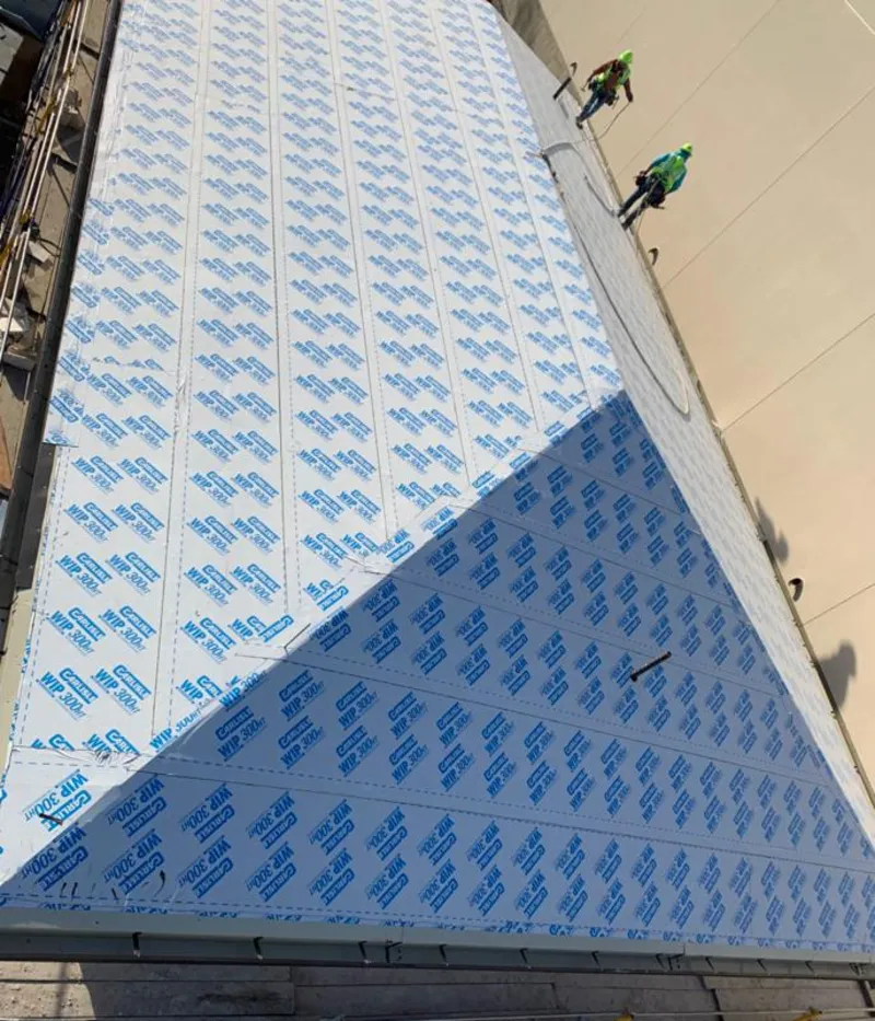 Professional roofers installing underlayment on a metal roof in South Elgin